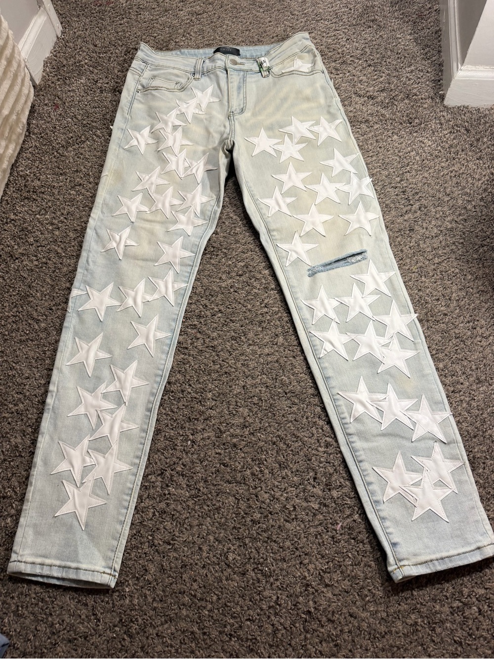 AMIRI Light Wash Skinny Jeans with White Star Appliqués